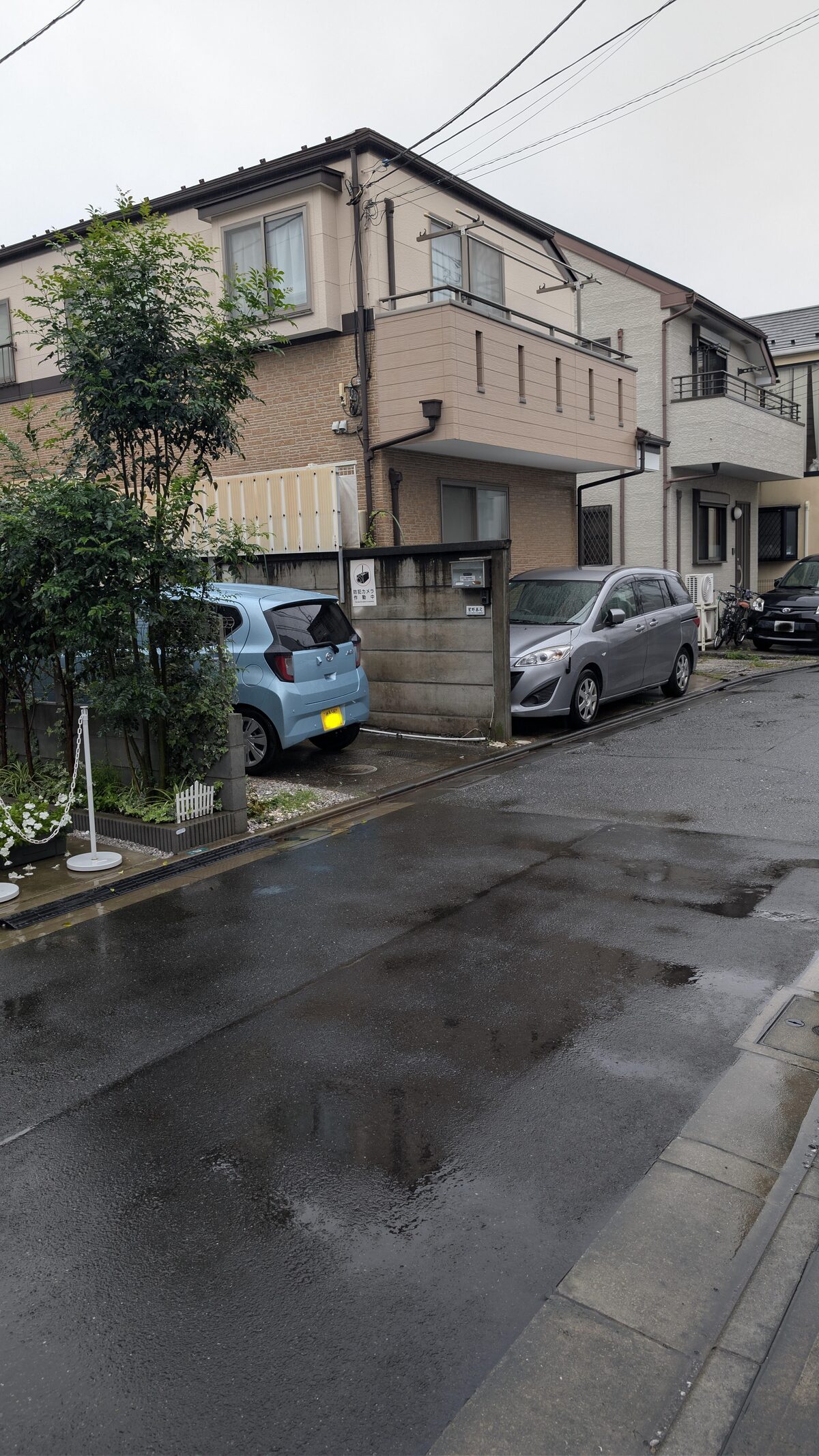 The same Tokyo street today, photographed in person: the old house and the white 350Z are gone, replaced by a new building